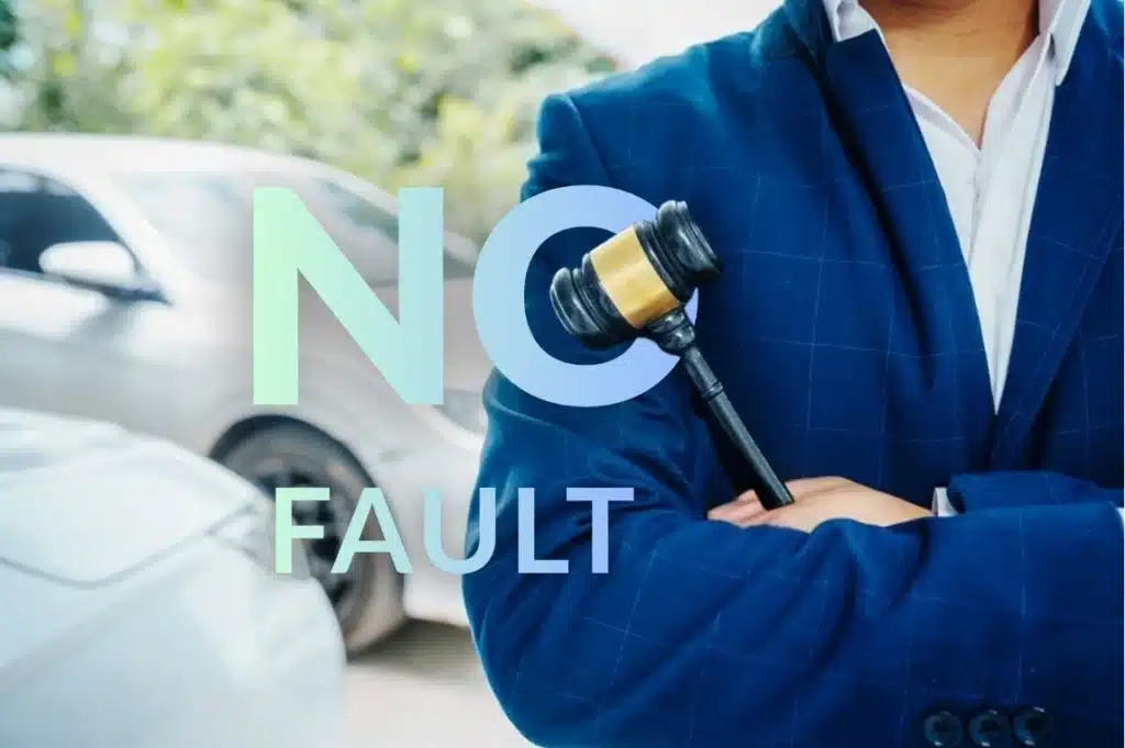 “No fault” text over a person in a suit holding a gavel, with cars blurred in the background.