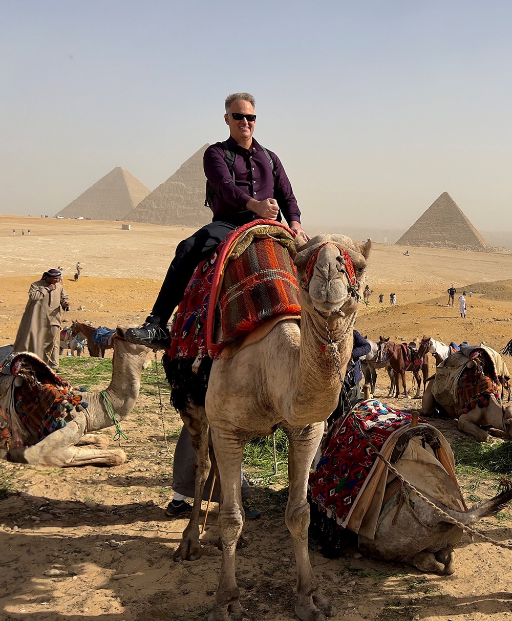 Dennis Hernandez Riding Camel at Pyramids