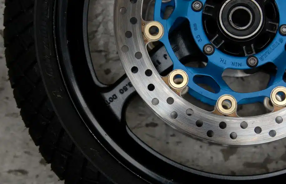 Close-up of a motorcycle wheel and brake disc, illustrating brake failure risks and mechanical issues that can contribute to motorcycle accidents.