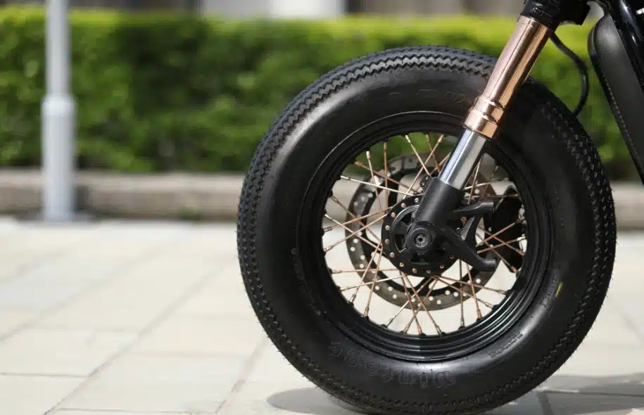 Close-up of a motorcycle front tire and wheel, illustrating how tire condition can affect motorcycle safety and accident risk.