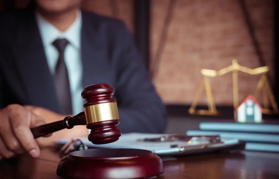 Judge holding a gavel with scales of justice in the background, representing punitive damages in Florida personal injury cases.