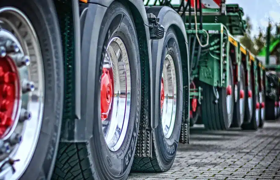 Close-up of tractor trailer tires and wheels, illustrating tire blowout risks and potential causes of commercial truck accidents.