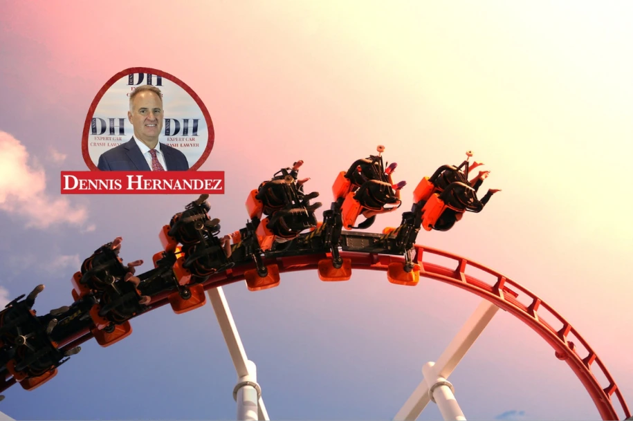 Roller coaster in motion at a theme park during sunset with the Dennis Hernandez Injury Attorneys logo overlayed.