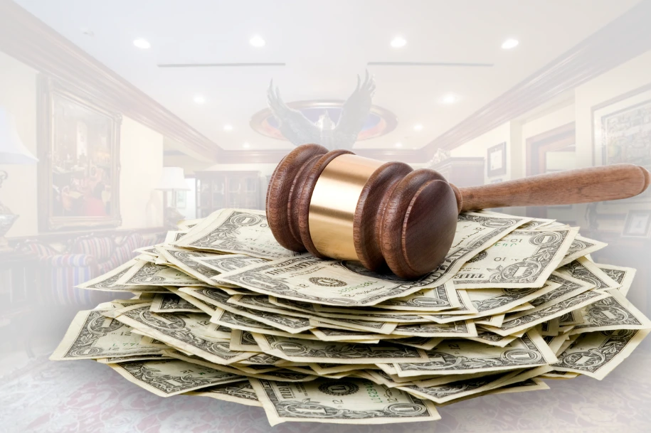 Judge’s gavel resting on a stack of U.S. dollar bills, symbolizing financial compensation and legal recovery handled by Dennis Hernandez Injury Attorneys.