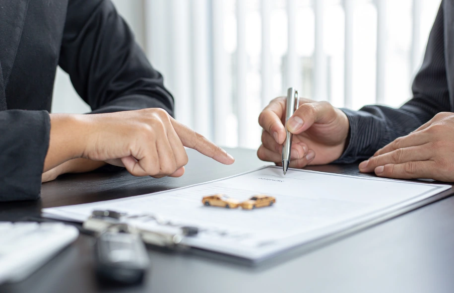 Client signing a legal document during a consultation with a personal injury attorney at Dennis Hernandez Injury Attorneys.