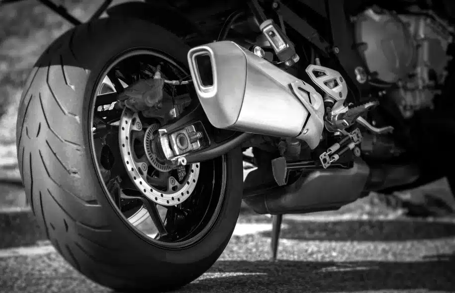Close-up of a motorcycle rear wheel, tire, and brake components.