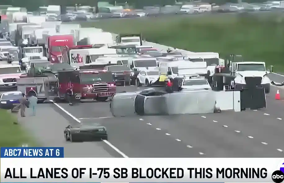 Multi-vehicle highway crash blocking traffic lanes on Interstate 75 with emergency responders present.