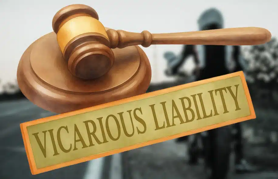 Gavel and sign reading vicarious liability with blurred motorcycle scene in background.