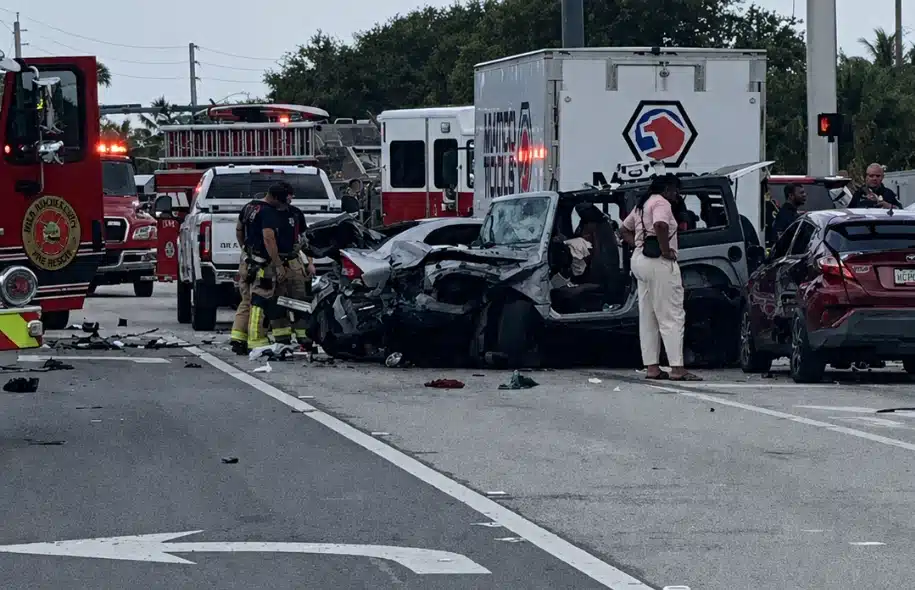 Emergency responders investigating a multi vehicle collision involving several heavily damaged vehicles at an East Ocean Avenue intersection.