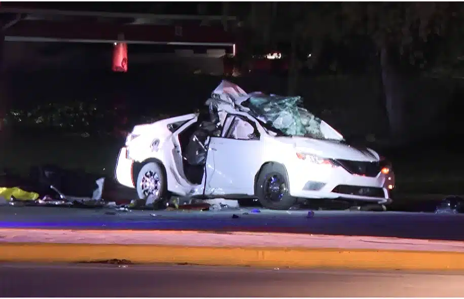 Heavily damaged white sedan at the scene of a fatal crash on West Hillsboro Boulevard in Deerfield Beach.